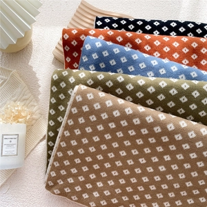 Classic double-sided plaid scarves in various colors with geometric diamond knit patterns