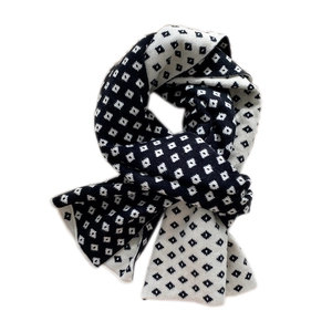 Classic black and white checkered knit scarf with geometric jacquard pattern for winter