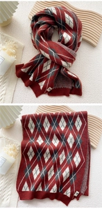 Macro detail of thick argyle knit scarf in red, white and grey with premium logo patch