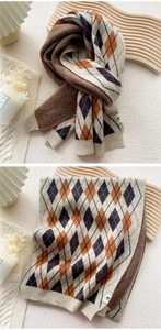 Detail of argyle knit scarf featuring navy and orange patterns with ribbed edges