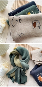 Detailed view of thick knitted scarves with cute cartoon elephant patterns and ribbed edges