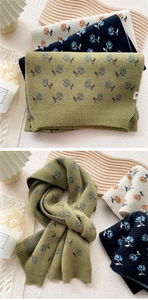 Close-up of vintage floral knit scarves showing olive green, black, and beige textures