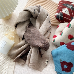 Thick knitted winter scarves with assorted patterns and textures on white surface