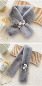 Detail of gray faux rabbit fur winter scarf with a stylish checkered crossover loop buckle