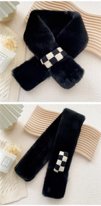 Detail of black faux rabbit fur scarf with a stylish checkered buckle closure