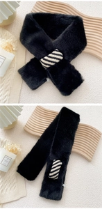 Detail view of black faux fur scarf with a decorative black and white striped ring