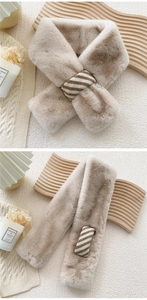 Detail of light brown faux rabbit fur scarf with striped knit cross-loop closure