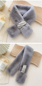 Detail of grey faux fur scarf with a grey and white striped knitted loop fastener