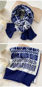 Detailed view of two-tone navy and white knitted scarf with geometric jacquard pattern