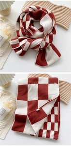 Close-up of red and beige checkerboard knit scarf with thick textured warm material