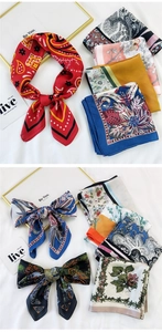 Flat lay of diverse printed silk scarves with floral patterns on a white fabric background