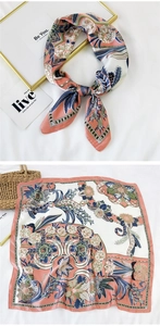 Detail showing floral print silk square scarf with coral and navy botanical patterns
