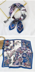 Detail of vintage floral silk scarf with royal blue edges and smooth satin texture