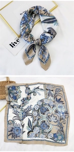 Detail of floral silk square scarf with blue blossoms and geometric chain border