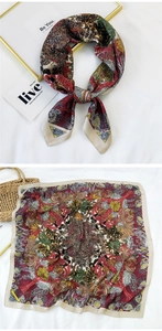 Detail view showing vintage ethnic print silk scarf pattern and elegant knotted style