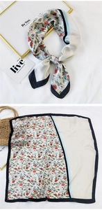 Detail view of floral silk scarf showing elegant patchwork patterns and lightweight fabric