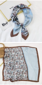 Detailed view of floral pattern square scarf in light blue with dark brown border trim