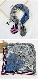 Detail of royal blue paisley square silk scarf showing tied style and full flat pattern