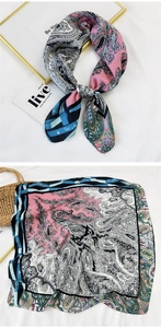 Detailed view of square silk scarf showing vintage paisley patterns and geometric stripes