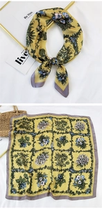 Detail of floral silk scarf with hydrangea print and elegant yellow and gray borders