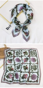Detail of light blue silk scarf with floral print and checkered border pattern