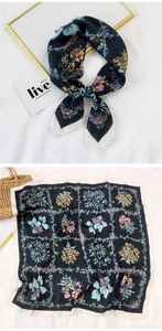 Detail view of square silk scarf with floral print and elegant white border