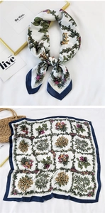 Detailed pattern of a square floral silk scarf with vintage navy blue borders and flowers