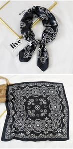 Detail of silk-like scarf with black and white paisley pattern for hair and neck