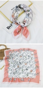 Detail of pink floral silk scarf showing both knotted style and full butterfly print design