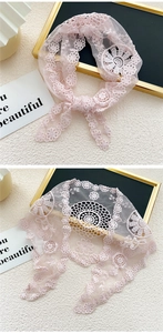 Détail d'un foulard en dentelle florale rose avec broderie et maille délicate