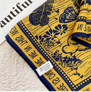 Detail showing 100% mulberry silk label on a yellow and navy square scarf, 53x53cm size