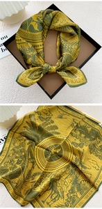 Close-up of silk square scarf showing nature forest patterns and premium gift packaging