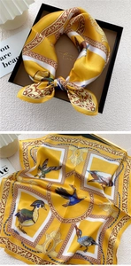 Detail view of yellow silk scarf with classic vintage duck print and ornate borders
