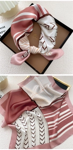 Detailed view of silk square scarf featuring geometric stripes and herringbone pattern
