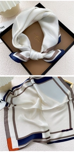 Detail of silk square scarf with geometric border patterns in blue, orange and brown