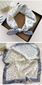 Detailed view of square silk scarf with bear prints in elegant gift box packaging
