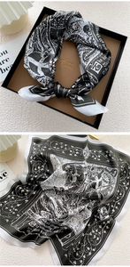 Detail view of a luxury silk scarf with vintage black and white medieval illustrations