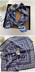 Detail of silk scarf featuring equestrian horse motifs and classic navy blue polka dots