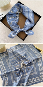 Detailed blue equestrian print silk scarf showing classical horse and strap patterns
