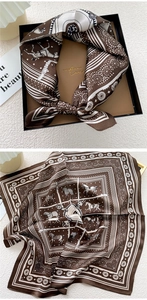 Detail view of equestrian horse print silk scarf with luxury gift box packaging