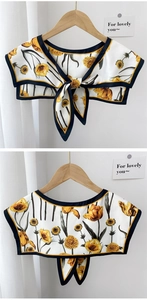 Detail of tulip print shawl with silk-like fabric, yellow flowers and tie-bow knot