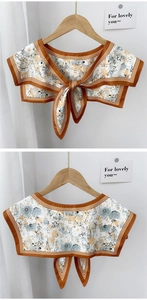 Detail of floral shawl collar with retro orange print and ribbon tie closure