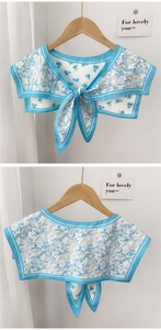 Detail view of blue floral chiffon false collar with navy style trim and tie closure