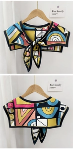Detail view of tie-front decorative shawl featuring abstract colorful geometric patterns