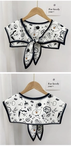 Detail of a cartoon print faux collar featuring black and white chicken patterns and ties