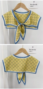 Front and back view of a yellow sailor collar shawl scarf with blue geometric wave patterns