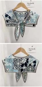Detailed view of floral shawl scarf with light blue vintage print and grey hemmed edges