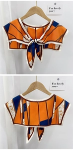 Detail of color-blocked faux collar scarf with orange and blue geometric patterns