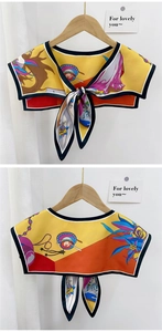 Detail of silk satin floral faux collar scarf with button closure on a hanger