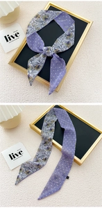 Detail of double-sided narrow silk scarf featuring floral prints and purple polka dots